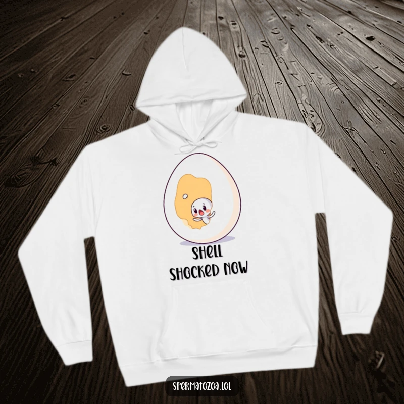 Funny tiny sperm character surprised by a giant egg, printed on a cozy hoodie for humorous comfort.